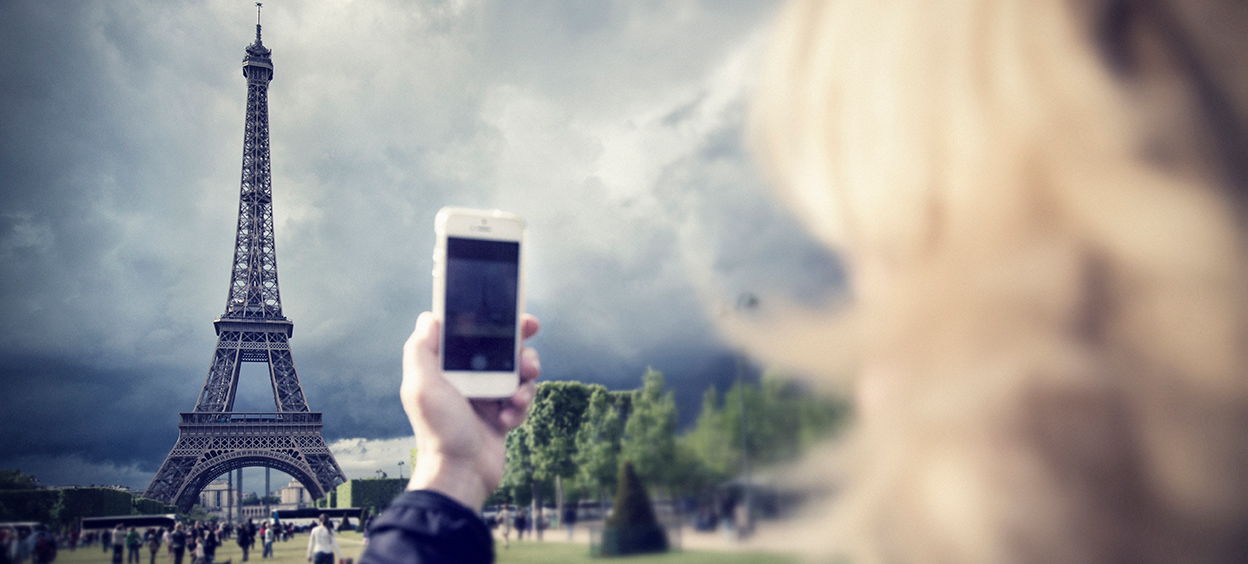 Woman photographing Eiffel Tower